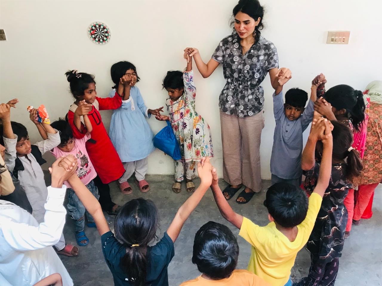 Teacher playing with kids at the school